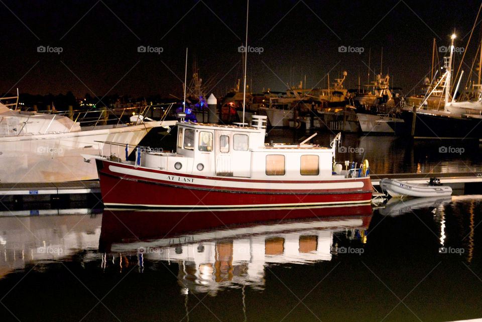 Tugboat. Reflection of tugboat in water