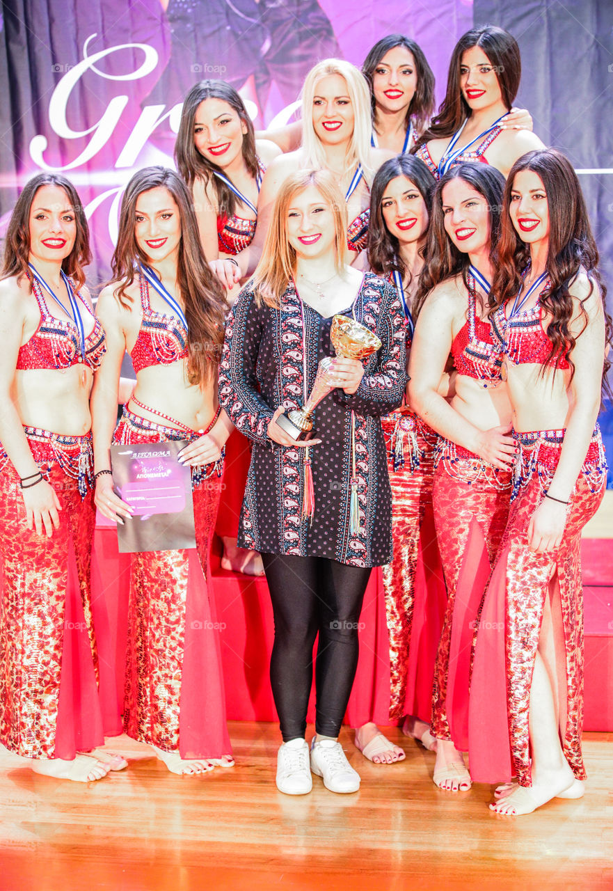 Beautiful Young Smiling Girls Winning Golden Trophy
