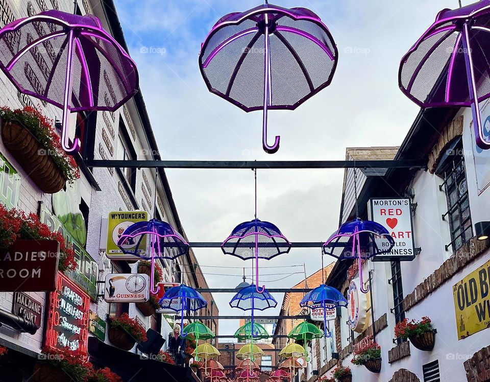 Multicolored umbrellas line the alley over the Duke of York pub in Belfast, Northern Ireland.