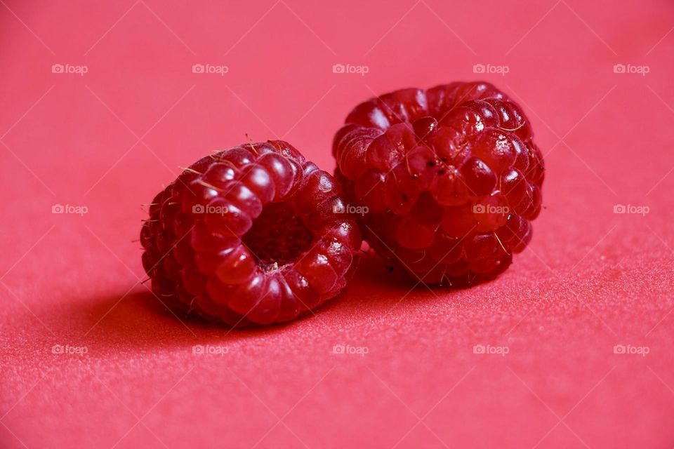 Close up of raspberries on red background