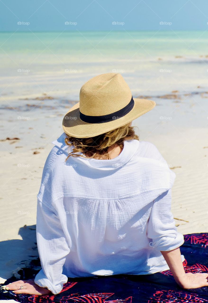 A woman takes in the stunning beauty of Playa Holbox on Holbox Island, Quintana Roo, Mexico.