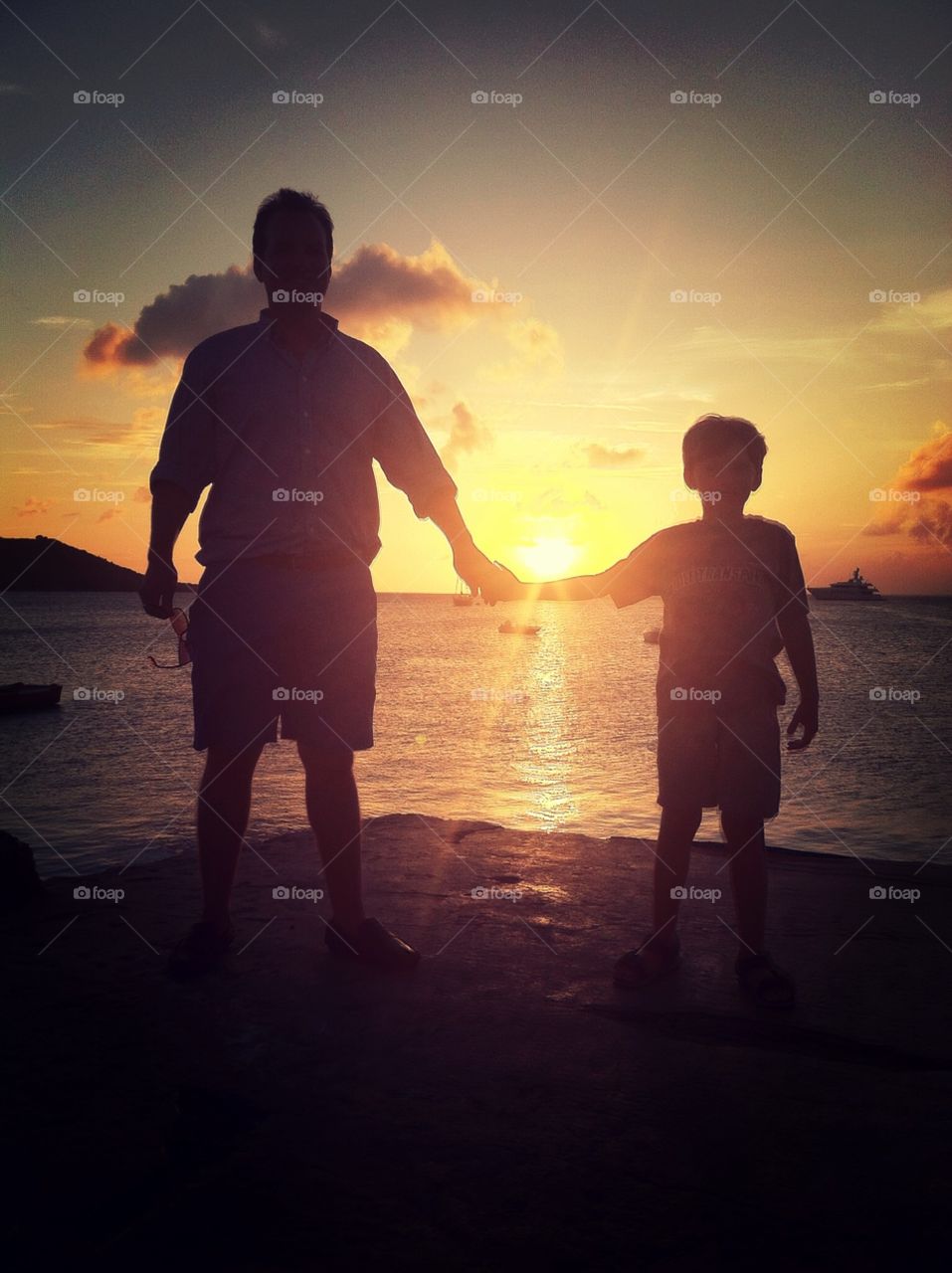 Backlit father and sun, sunset in st. Maarten 