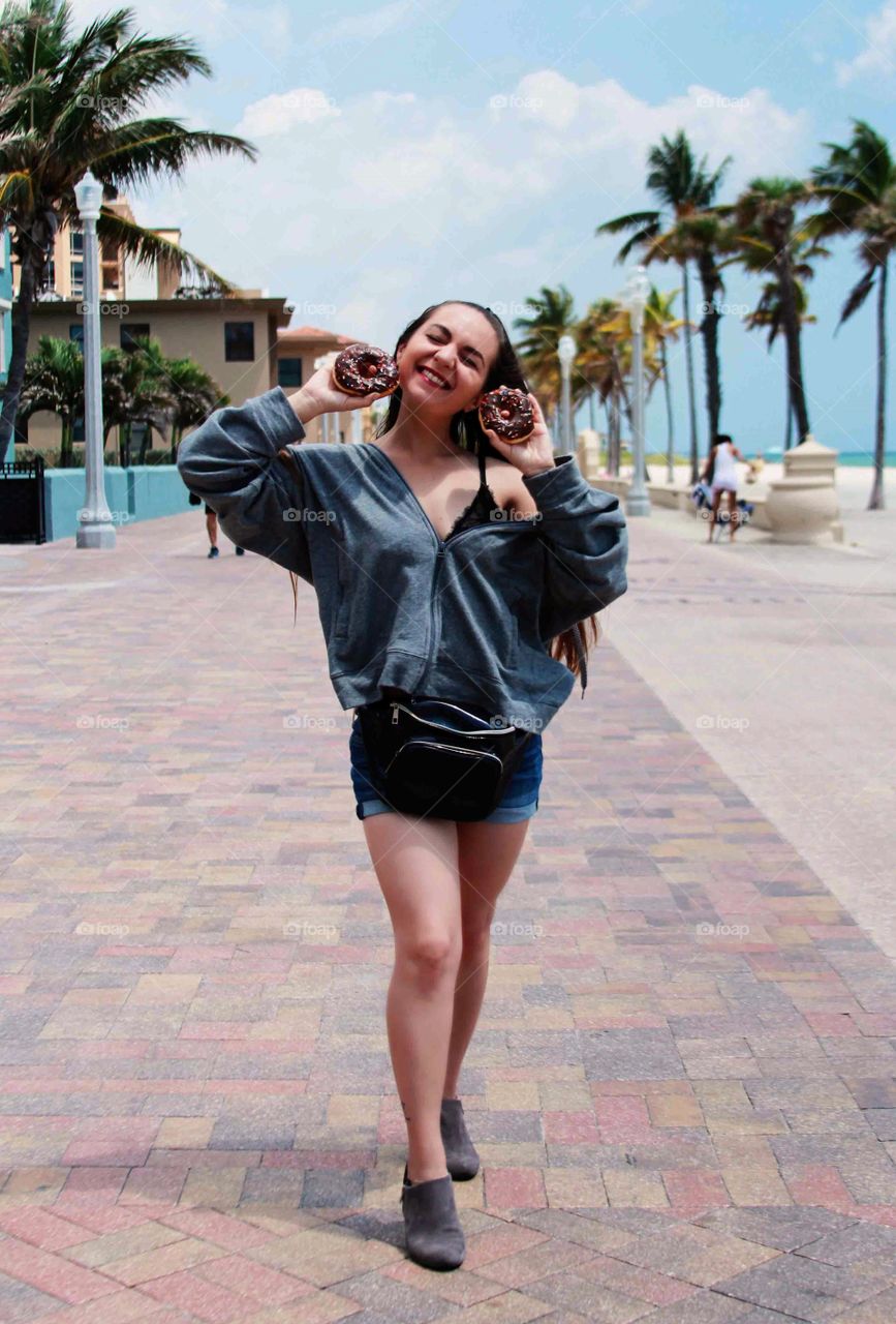 woman on the beach with donuts