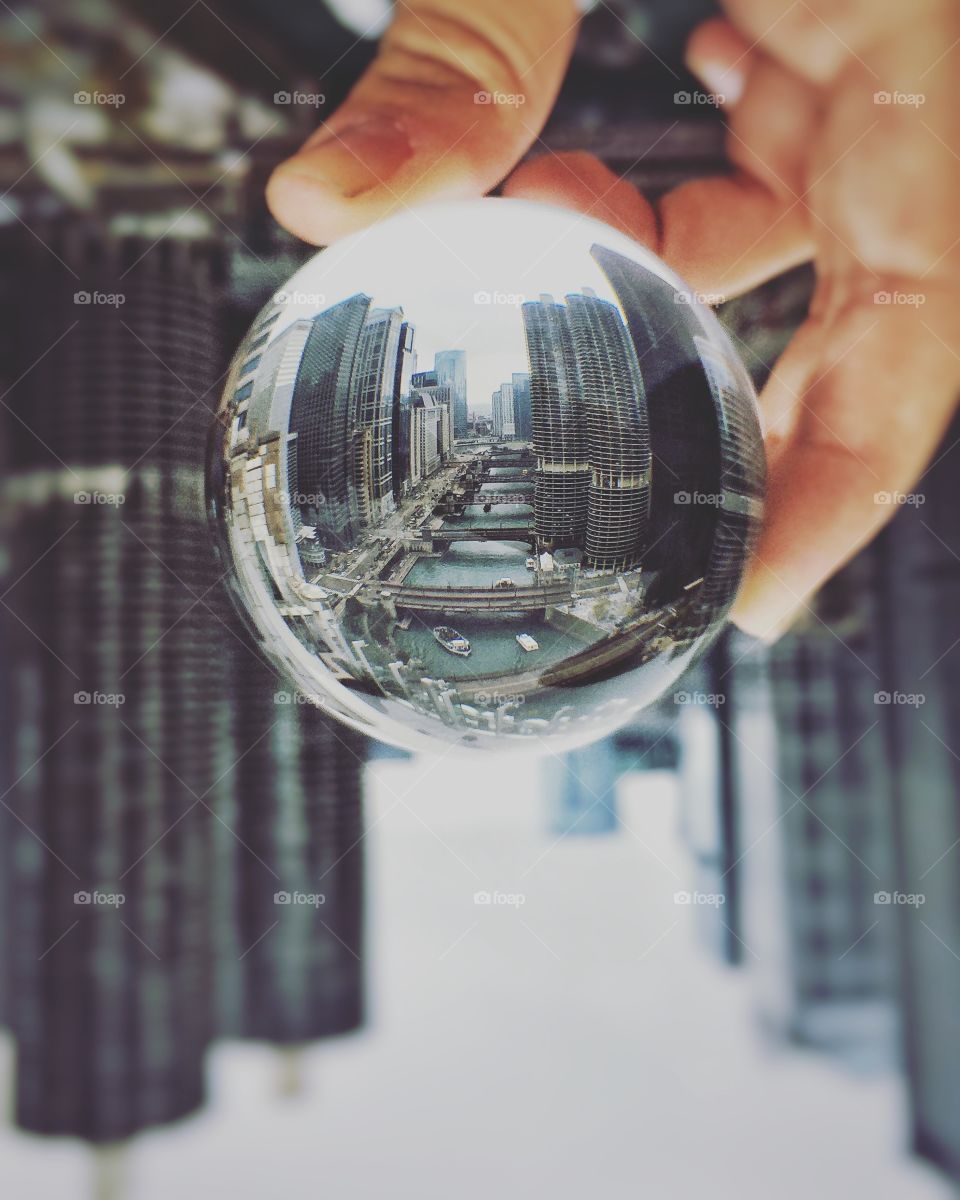 A reflection of the Chicago river in a crystal ball. Reflection is of the river with boats, bridges, and River City Apartment a