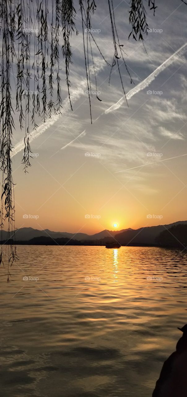 Sunset at West Lake Xihu in Hangzhou, China.  Xihu is one of the best scenic spots in China to enjoy the sunset.