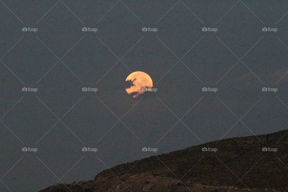 August Sturgeon Moon Behind Clouds 