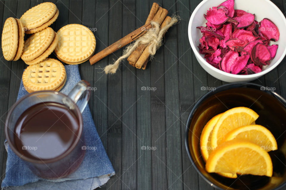 Tea tradition, tea, cup, mug, hot drink, cinnamon, cookies, napkin, jeans, denim napkin, fruit tea, flower tea, citrus, orange, lemon, rose petals, cookies, chocolate cookies, vanilla, vanilla sticks