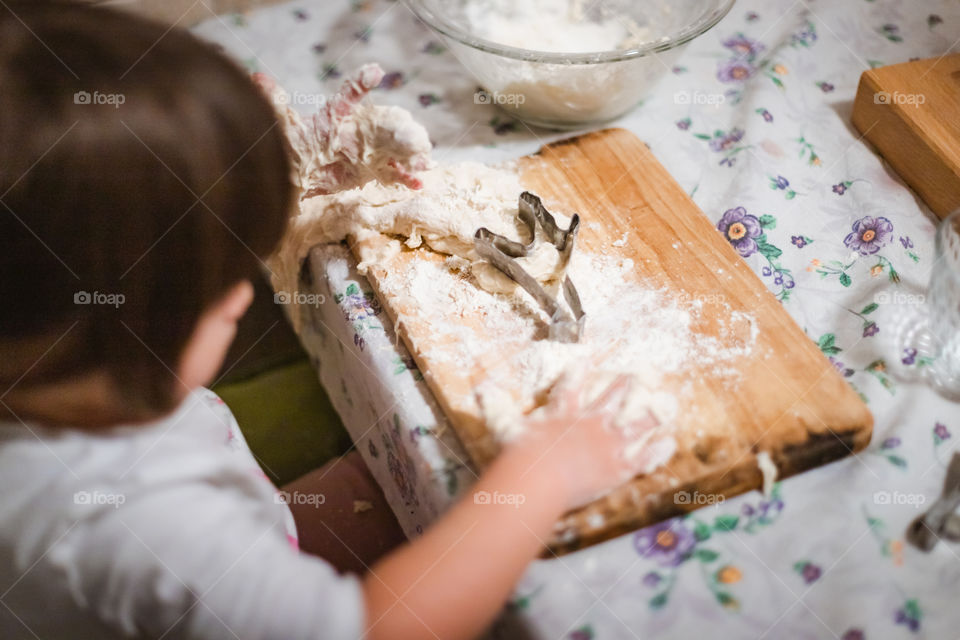 Child while playing with pasta and flour during the quarantine from Covid-19