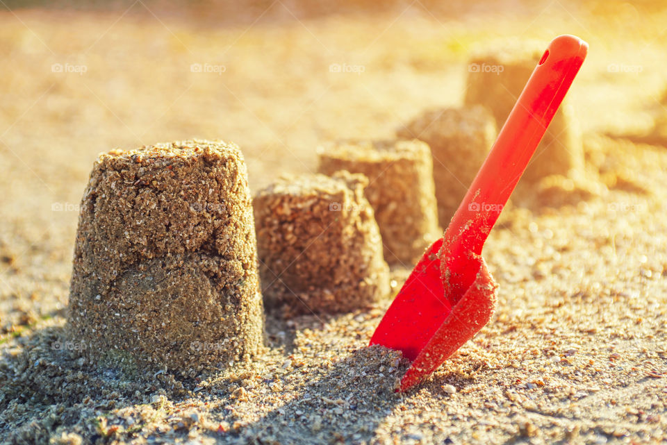 Holiday concept with form of sand on the seaside. Form of sand and beach shovel on the beach
