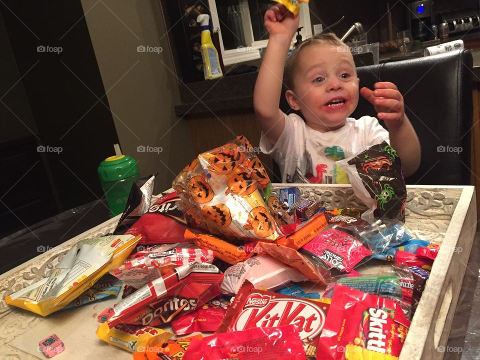 Toddler boy excited Halloween candy 