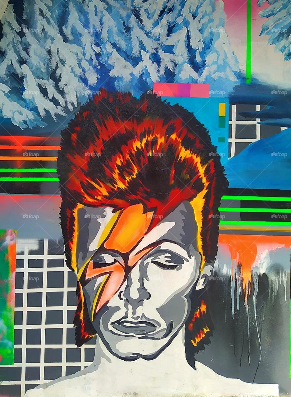 Anger.  Graffiti.  A woman's face is painted on the wall, which is crossed by lightning bolts.  Facial expressions, colors and lightning show anger