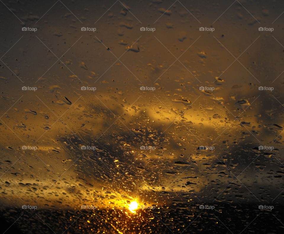 Raindrops on the glass and a sunset