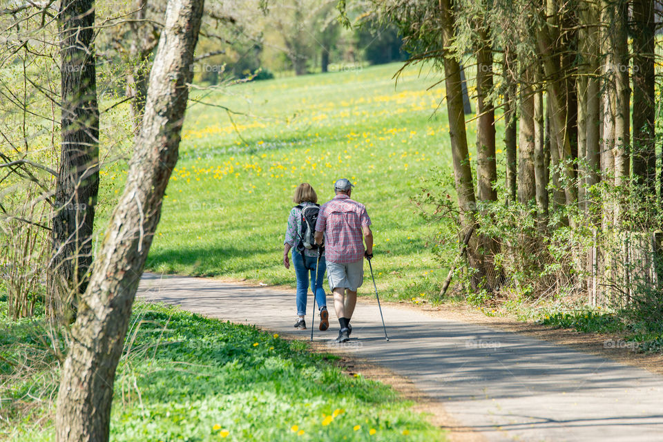 senior couple walking in the beautiful nature in springtime