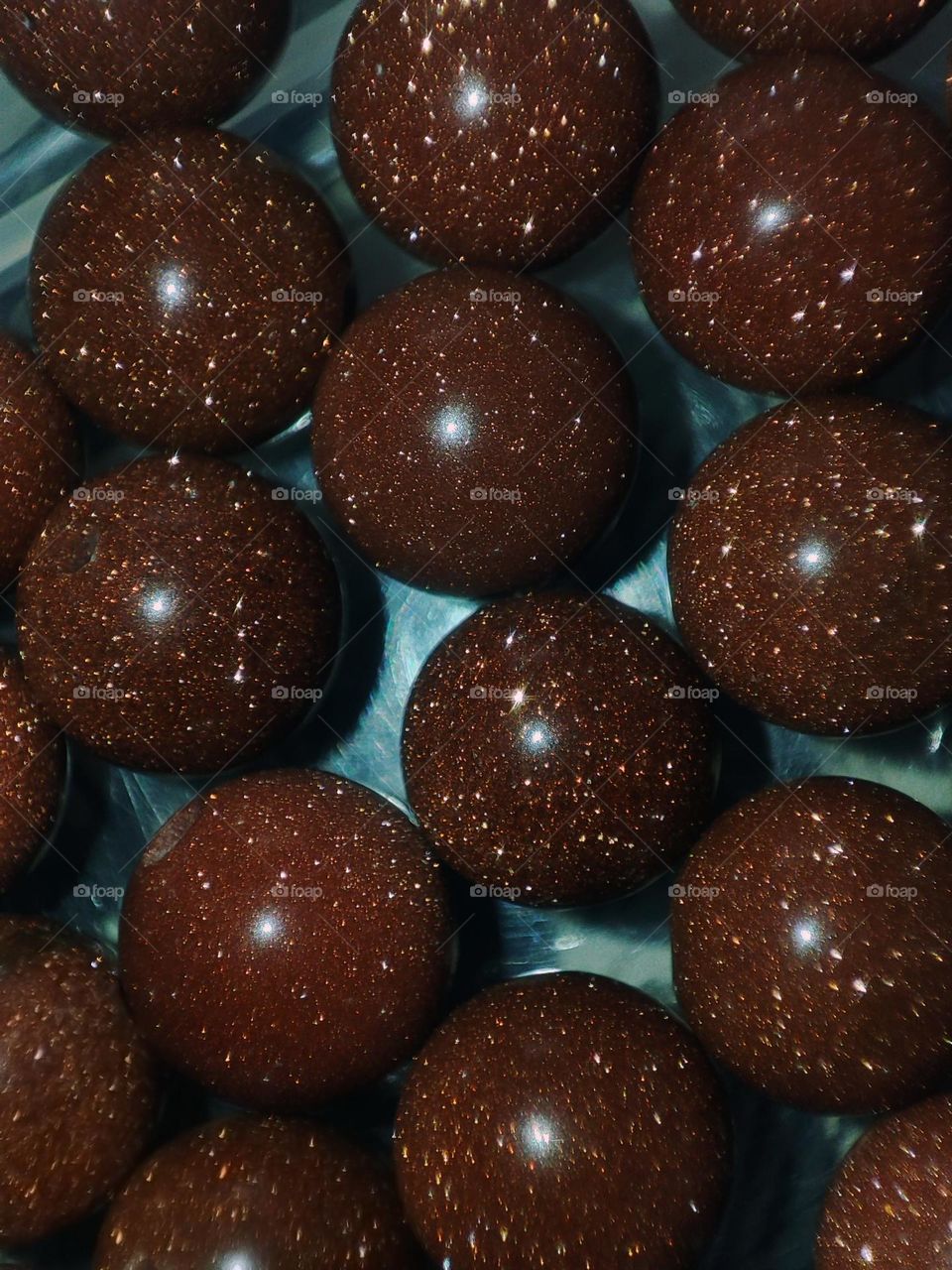 Macro photograph of a natural aventurine stone lying on a table