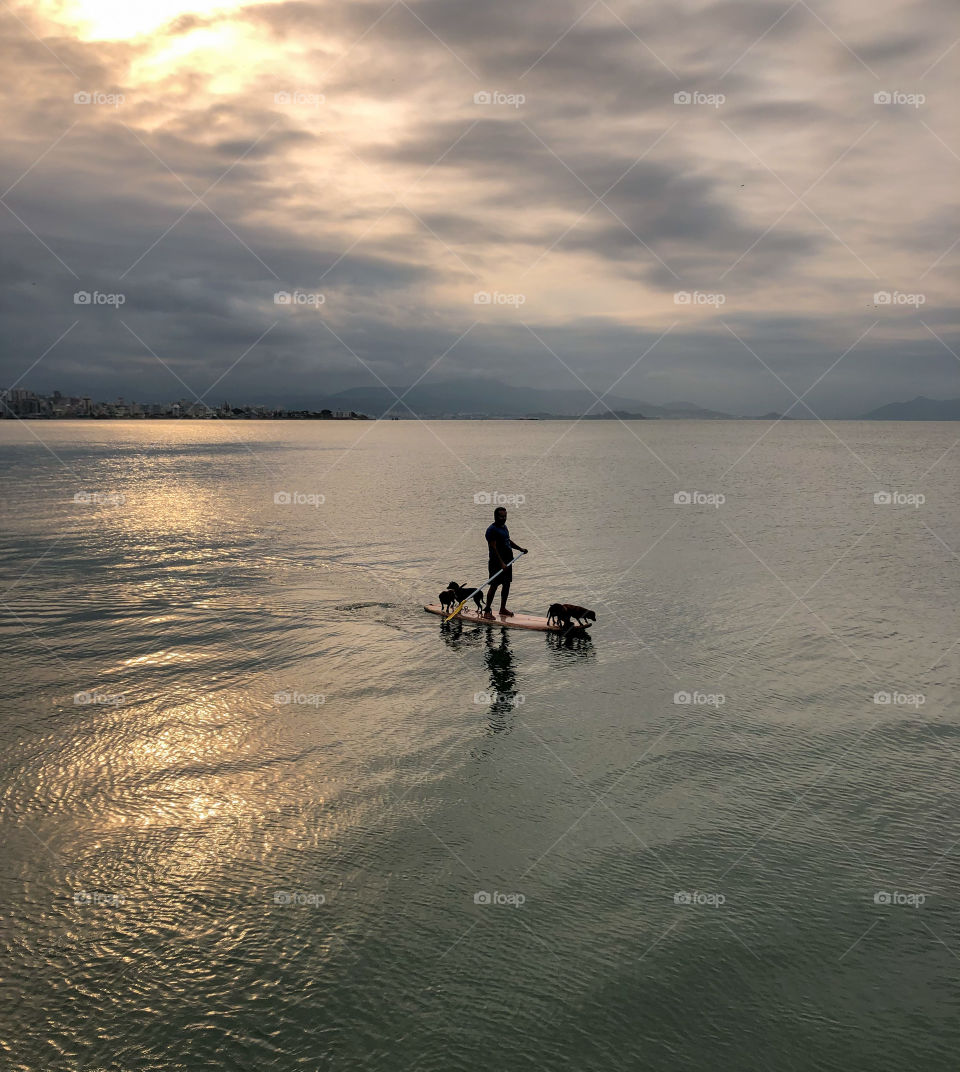 exercising in the sea at sunset