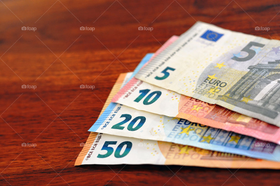 Euro money banknotes on wood table.
