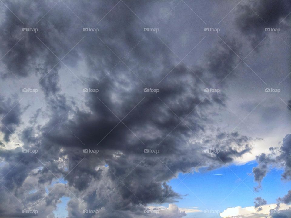 It's summer thunderstorms to shower with an eye to clear blue sky As seen from The Home Depot parking lot. look closely at the opening and you can see a flight traveling from ORD to Heathrow