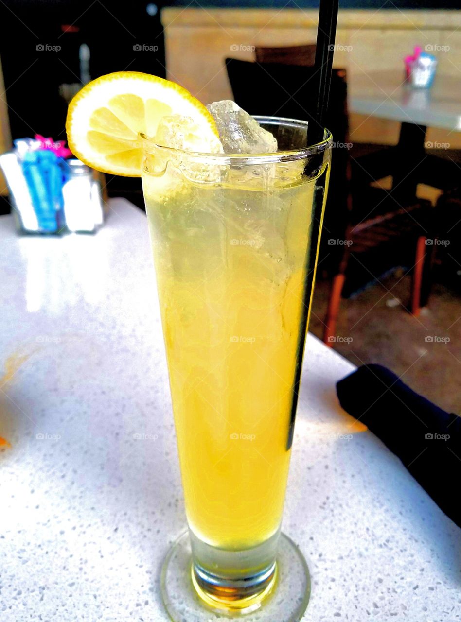 A white honey sangria with a wedge of lemon