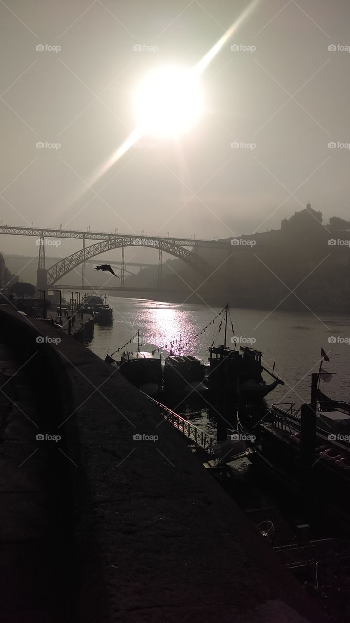 Douro river in Porto, Portugal with Dom Luis bridge and beautiful sun