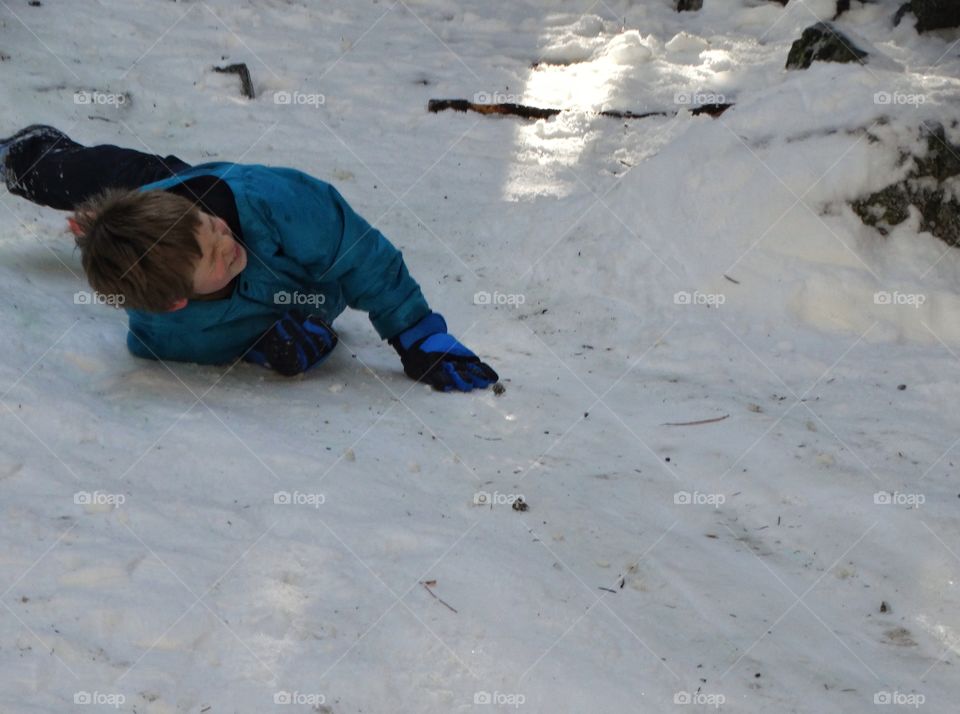 Boy Rolling Around In The Snow