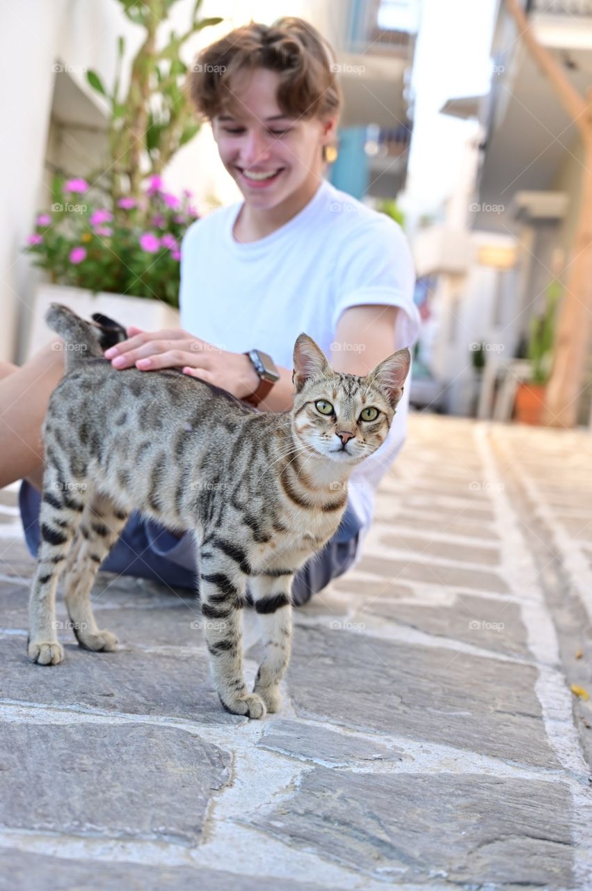 Kids and animals; boy with handsome tabby cat