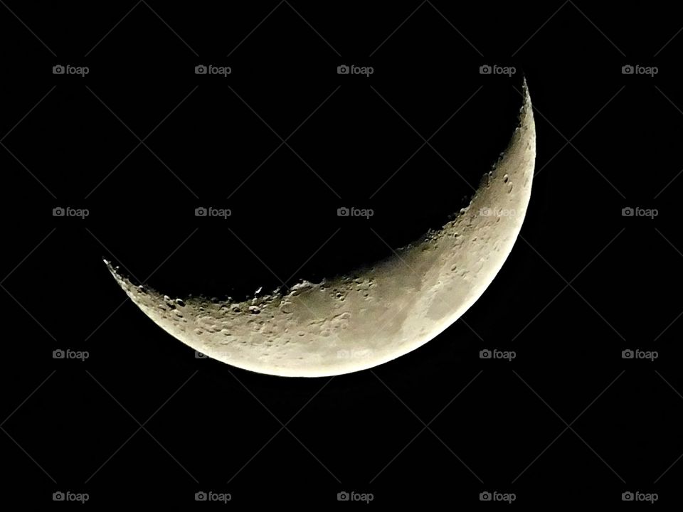 The moon tonight - First Phase after the new moon. The moon is close to the sun in the sky and mostly dark except the right edge. 