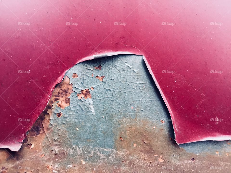Peeling paint on rusted steel surface 