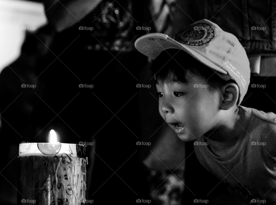 when a child looks at a giant candle burning with amazement