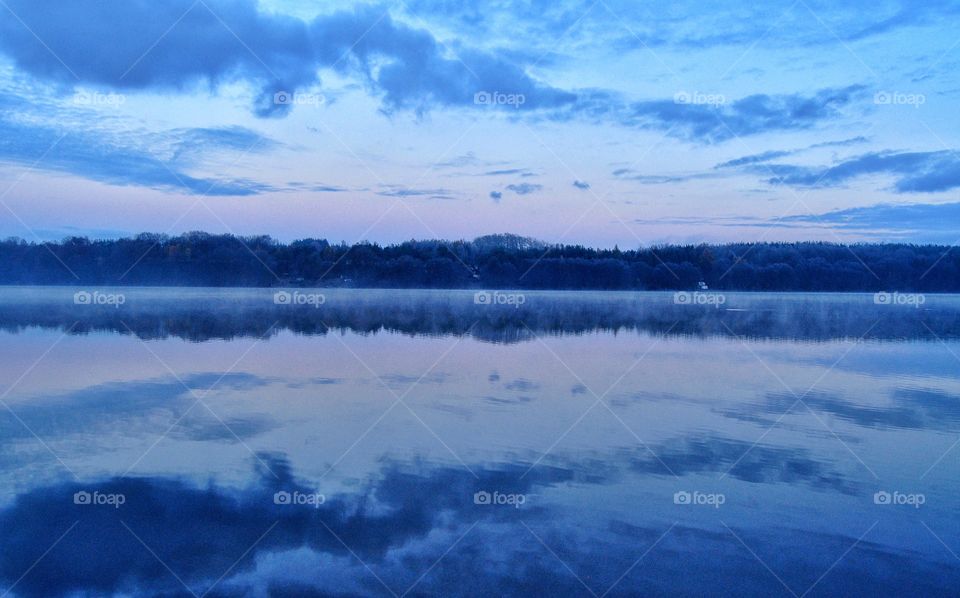 foggy morning at lake in polish countryside