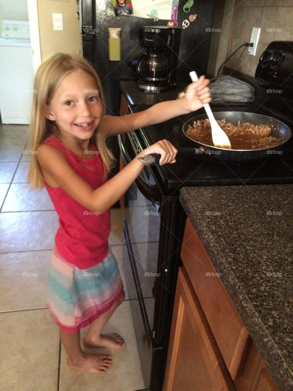 Little girl cooking dinner