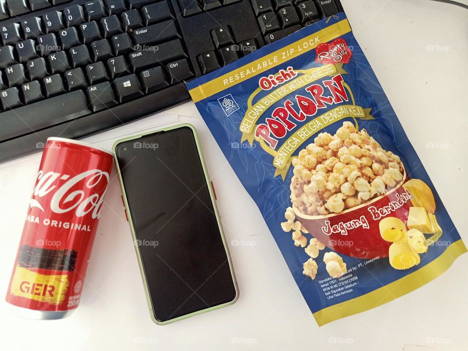 High angle view of soda and popcorn