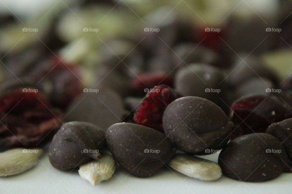 Dark chocolate chips, dried cranberries, sunflower seeds and pumpkin seeds close-up