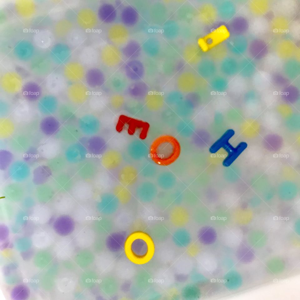 Water table with letters and colour marbles 