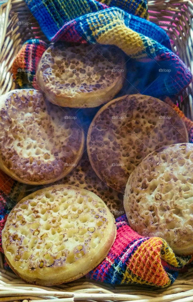Hot crumpets with a kitchen towel