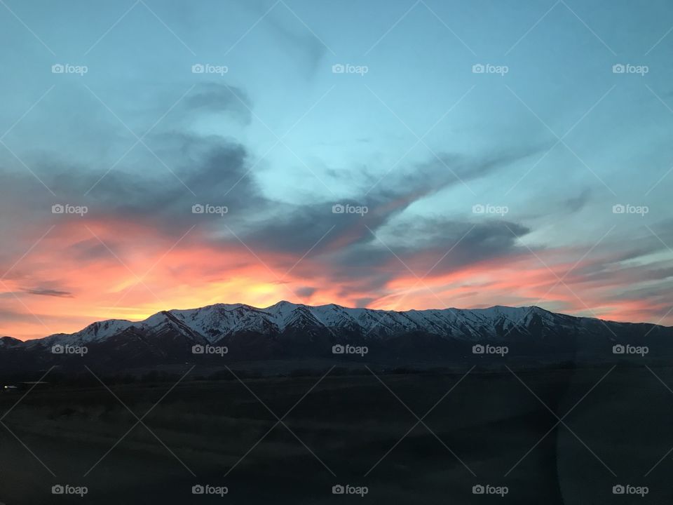Sunset over snow capped mountains