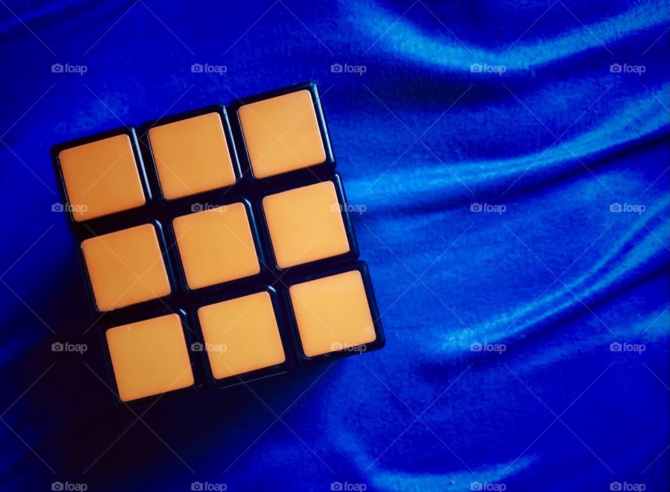 Orange cube displayed on a blue background