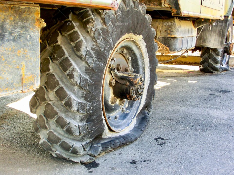 flattened old truck wheel