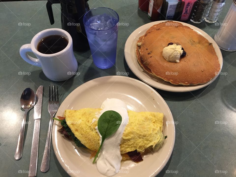 The perfect breakfast. Coffee, water, blueberry pancakes, aaand...a spinach, bacon, and mushroom omelette.