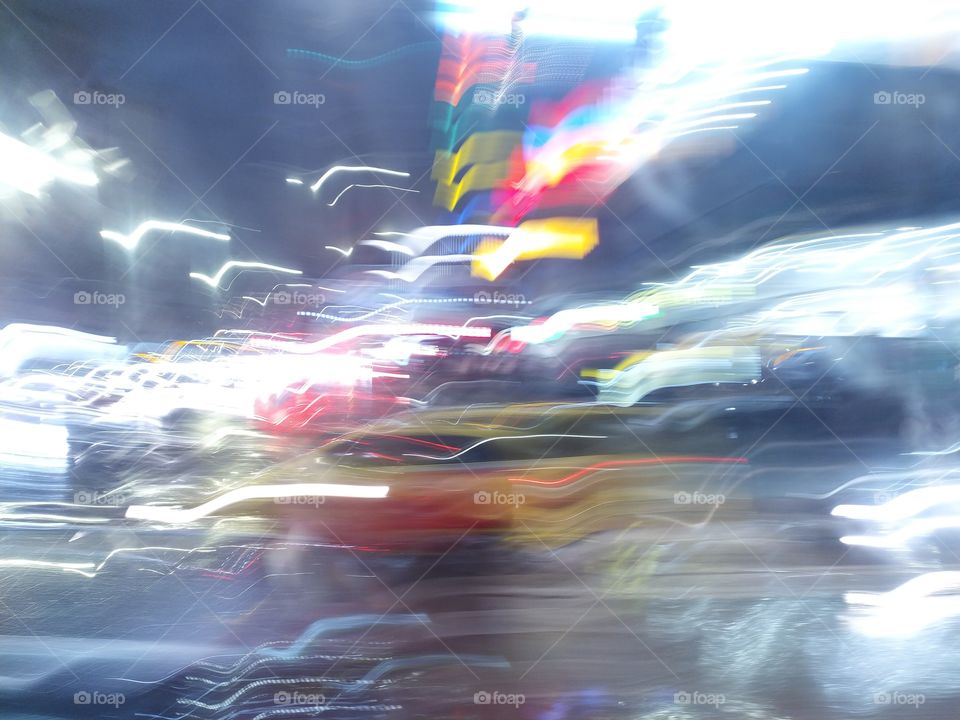 City at Night with Shining Lights Smeared by the Rain and Glass Reflections. Lights turn into Birds and Fly away.