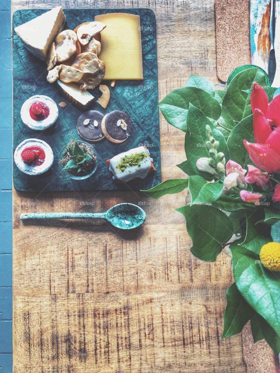 Green marble platter with cheesecake and cheeseboard