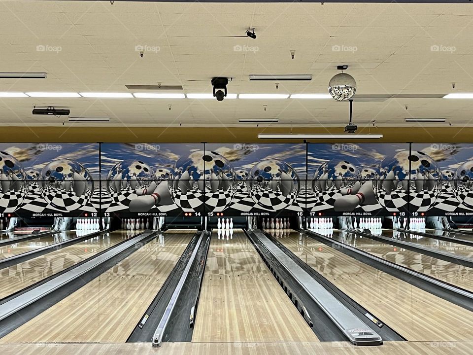 Bowling alley game with multiple lanes to throw down your ball and knock down the pins.  Disco ball on the ceiling for events.  