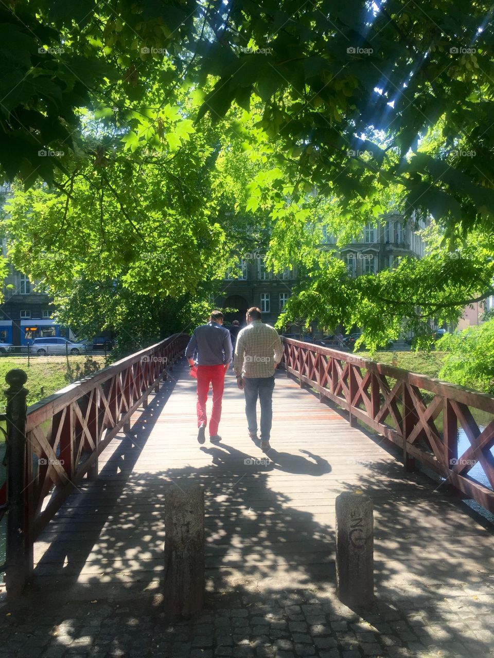 Two guys crossing a bridge