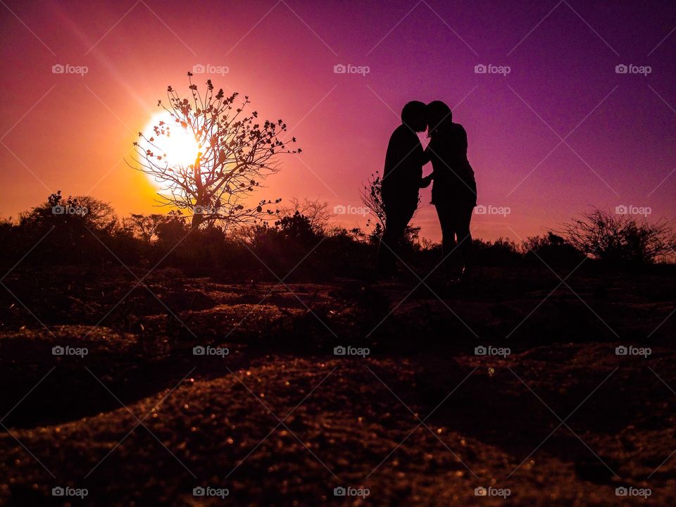 Silhouette of couple kissing