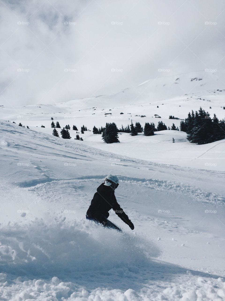 Snowboarding in a powder field