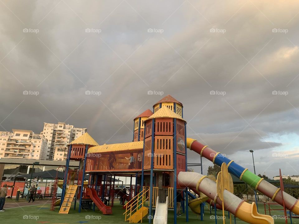 Clouds and rainbow in playground 