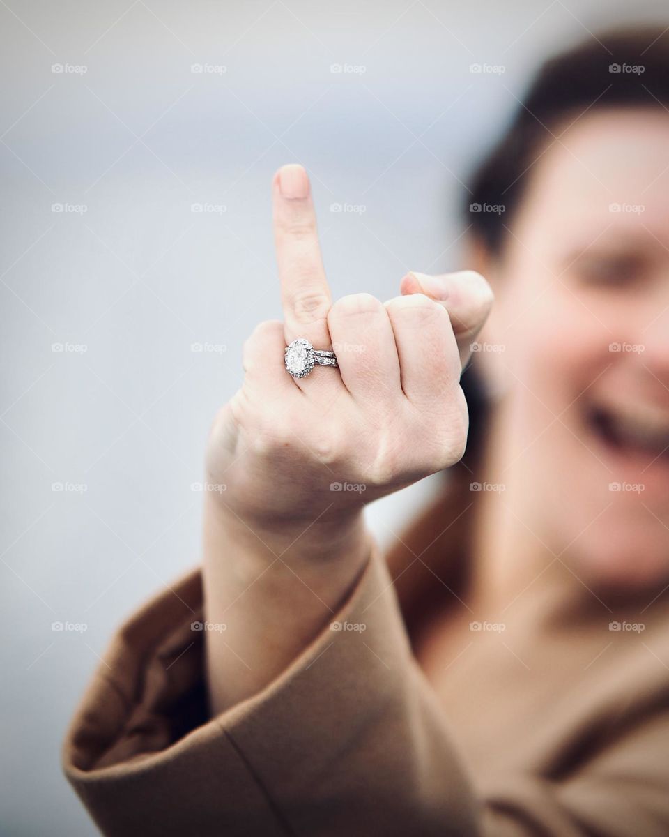 Moody portrait of a woman showing off her wedding ring - background blur bokeh