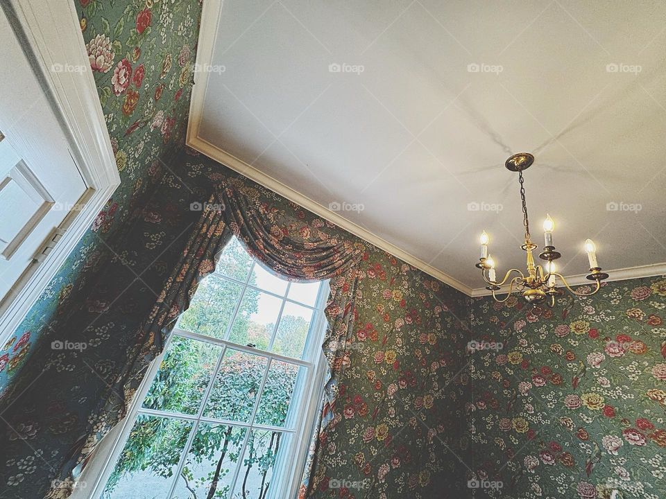 Room with wallpaper and drapery in floral print 