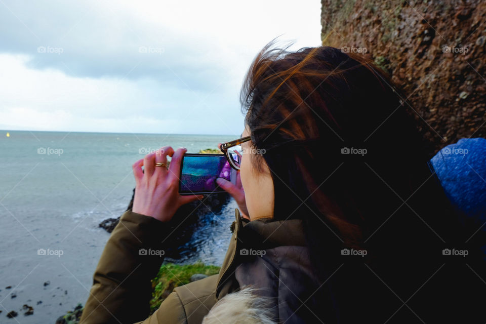 Girl taking photo of gorgeous landscape