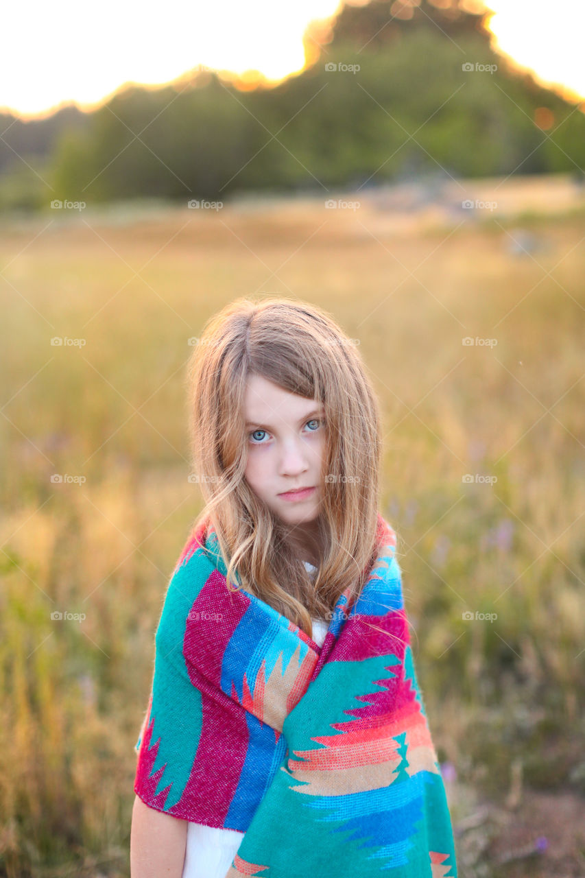 “Native to nature” young blue eyed girl portrait outdoors in Tahoe open fields.  