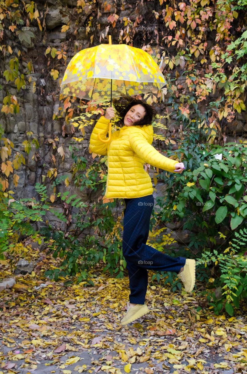 Woman with Umbrella on Autumn Background